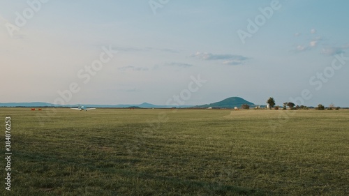 Bilde på lerret Family stands next to airfield on the countryside under beautiful weather