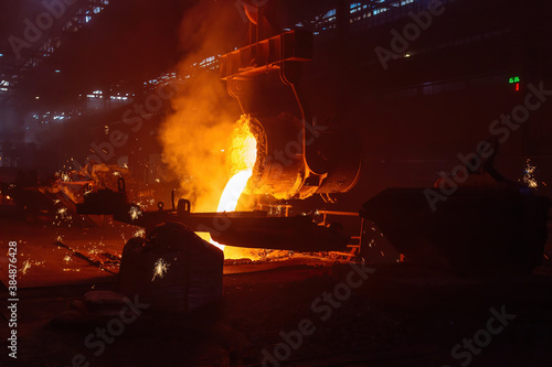 Metal casting process in metallurgical plant. Liquid metal pouring into molds