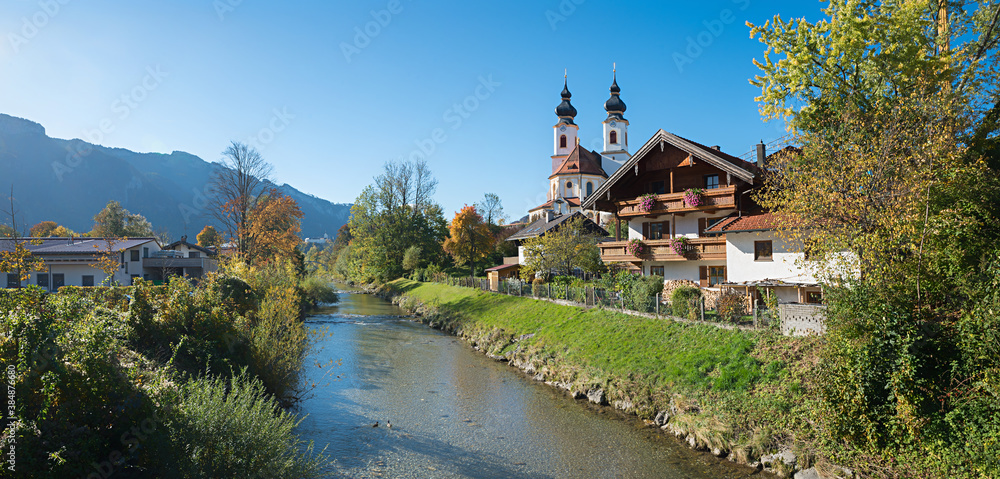 tourist destination Aschau im chiemgau, autumnal landscape with church and river Prien, upper bavaria tourist destination Aschau im chiemgau, autumnal landscape with church and river Prien, upper bavaria