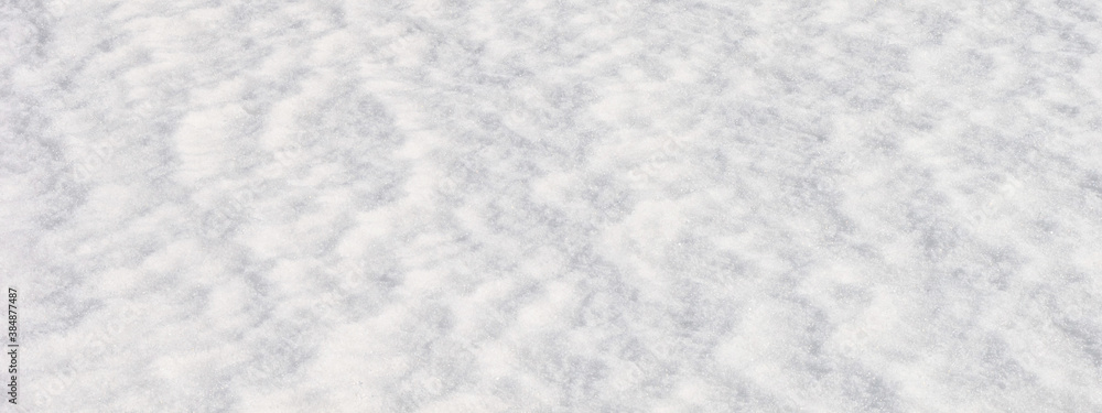 White snow surface background - top view of fresh snow texture on the ground, closeup, panorama, banner