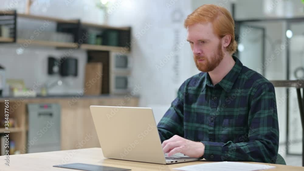 Young Beard Redhead Man in Cafe using Laptop Young Beard Redhead Man in Cafe using Laptop