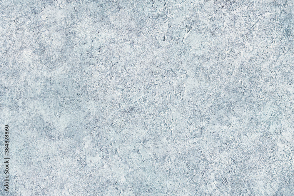 Abstract light blue plastered textured grunge background in the form of a rough covered stucco wall, closeup