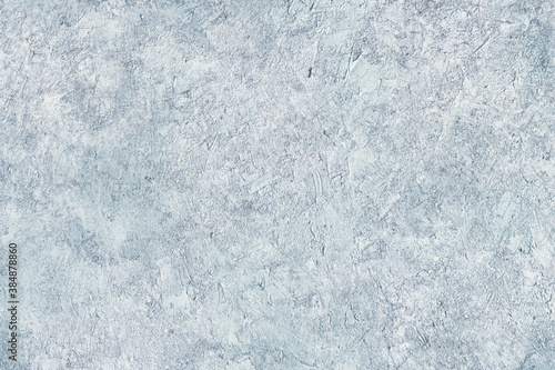 Abstract light blue plastered textured grunge background in the form of a rough covered stucco wall  closeup