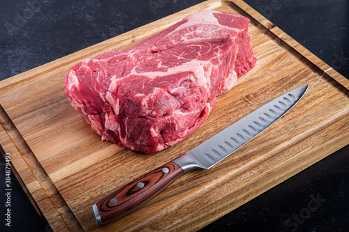 Boneless Beef Chuck Roast on a cutting board with a carving knife in the kitchen