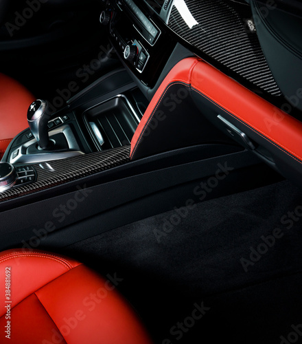 Modern car dashboard red perforated leather interior. 