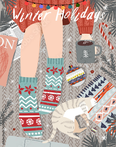 Merry Christmas and Happy New Year!
Vector illustration of a cozy winter still life with a top view: a girl with a cup of coffee in socks, a pet cat, Christmas tree branches, Christmas balls. 