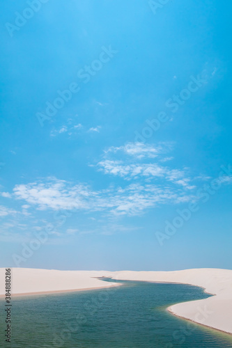 Vertical landscape of crystalline freshwater lagoon and white sands in the dunes of Lençóis Maranhenses National Park, Brazil