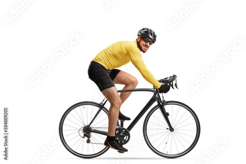 Male cyclist riding a road bicycle and looking at the camera