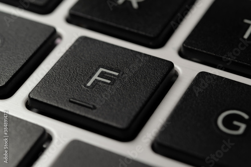 Close-up of an F Key of a Laptop Notebook Keyboard Letters Press