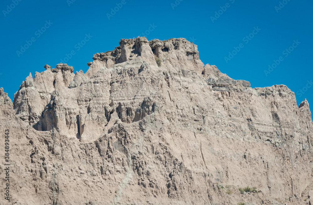 Layered Rock formations, steep Canyons and towering Spires of Badlands National Park in South Dakota. USA.