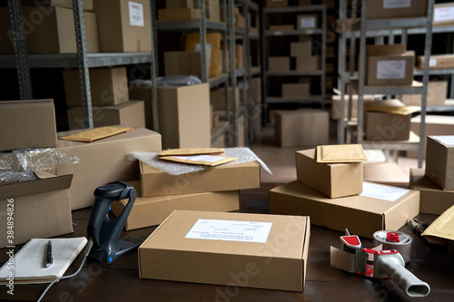Distribution warehouse background, commercial shipping order boxes for dispatching on stockroom table, post courier delivery package, dropshipping commerce retail store shipment storage concept. © insta_photos