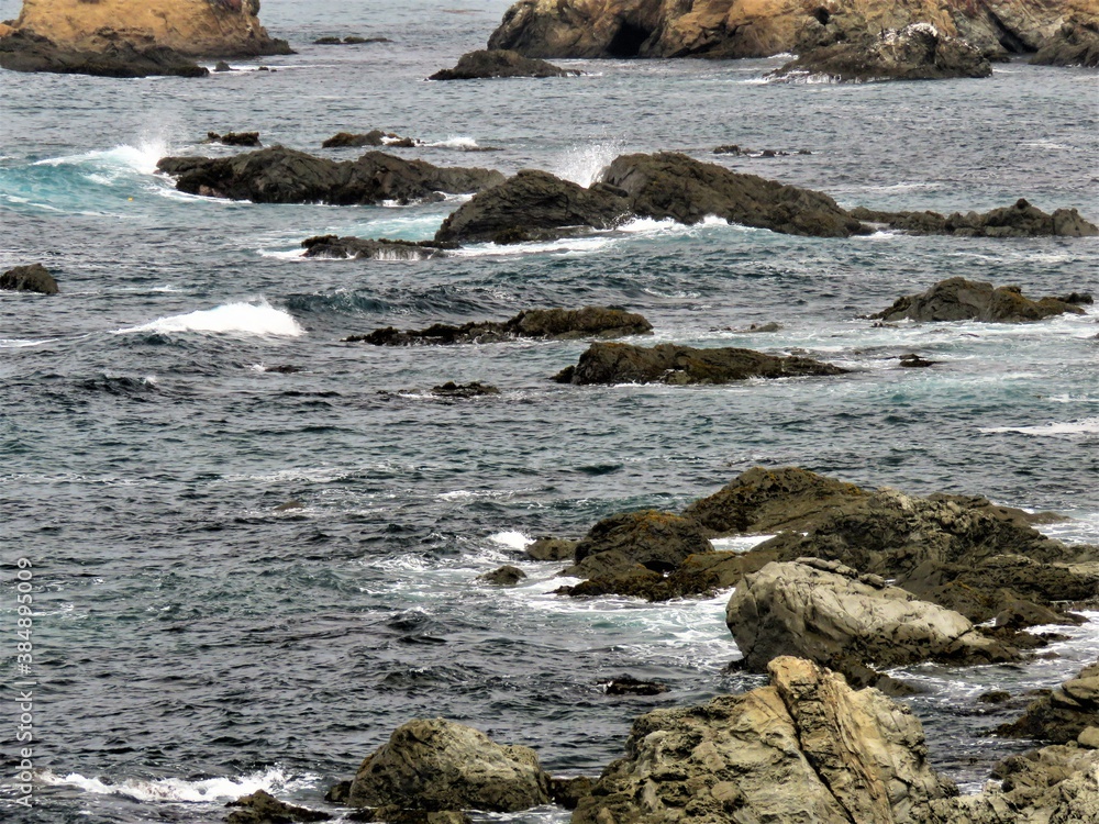 View of the Pacific Ocean and splashing water on the rocks