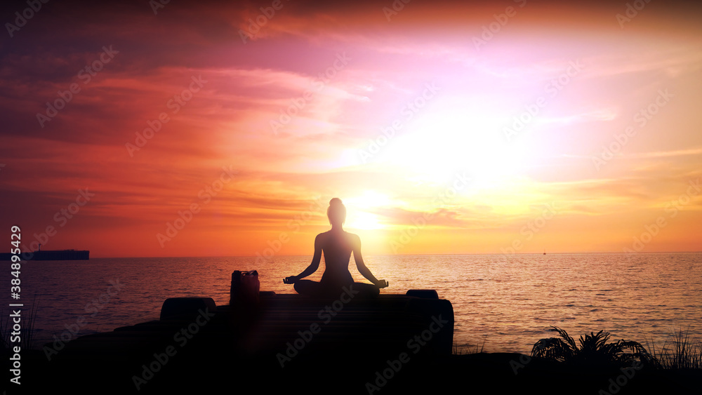 Meditation at bright sunset in the ocean.
