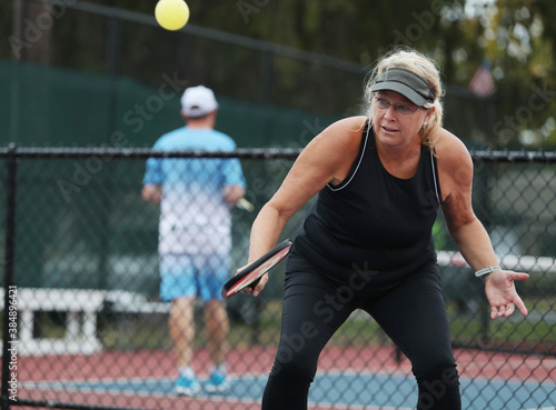 Senior woman competes in a pickleball tournament.