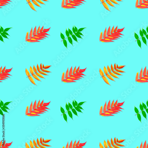 Seamless pattern. Colorful Autumn leaves isolated on a blue background