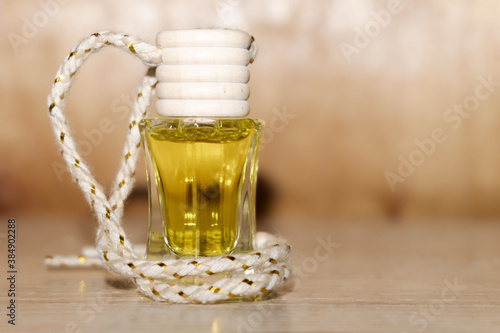 Pine nut oil in a glass bottle with a wooden lid on a wooden background