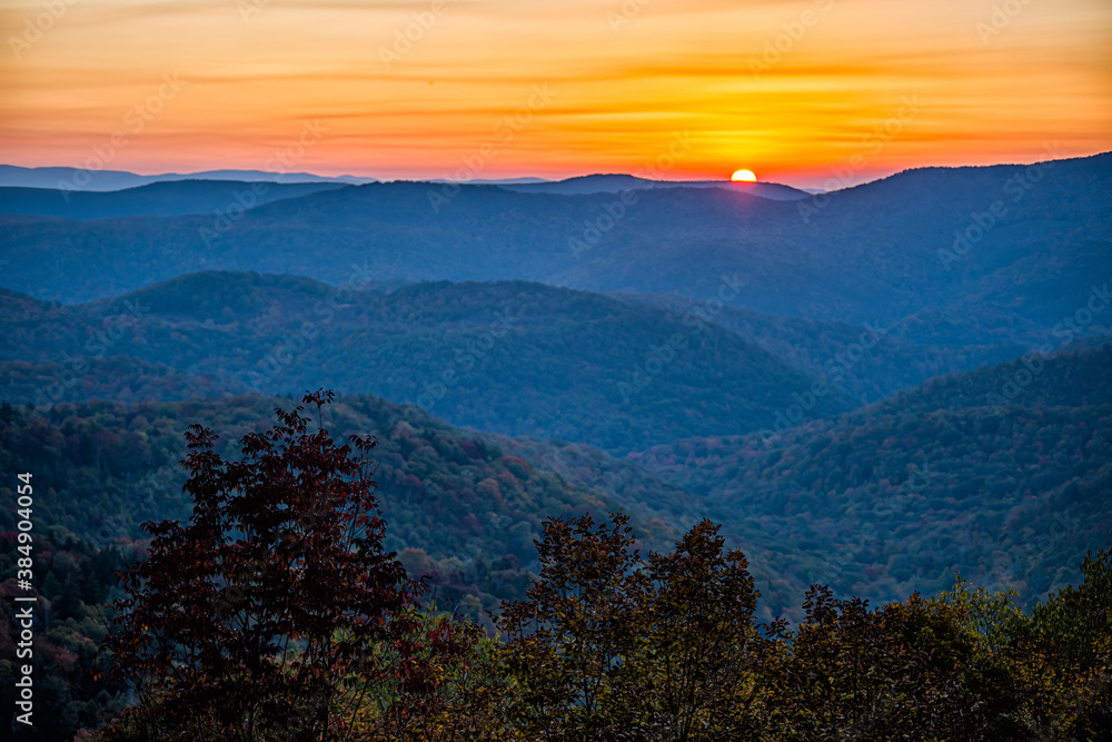 2020 Fall autumn season foliage with sunrise morning at Highland Scenic highway 150 road in West Virginia Monongahela National Forest Appalachian Mountains colorful sun