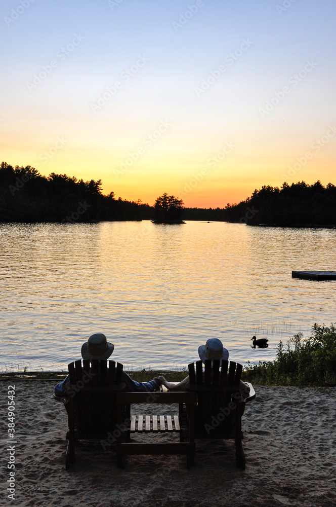 A couple enjoys a quiet sunset at the lake.