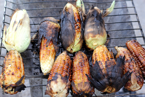 view of charcoal grill with burnt roasted corn