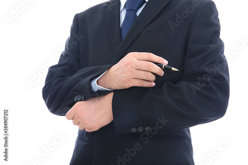 Male in black suit holds signature pen in hands