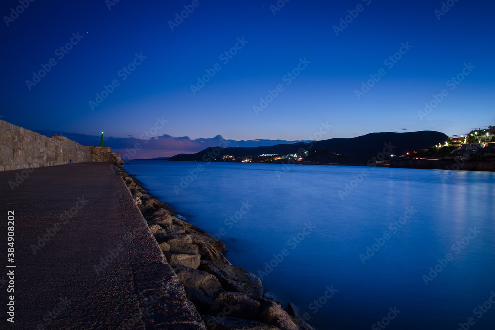 Breakwater at the entrance to the harbor of Peniscola at night, Castellon, Spain