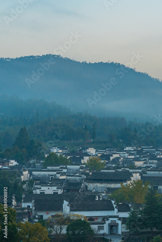 Fototapeta Naklejka Na Ścianę i Meble -   Panorama view of Xidi village, an ancient Chinese village in Anhui Province, China, a UNESCO world cultural heritage site, shot at sunrise with fog in the mountains.