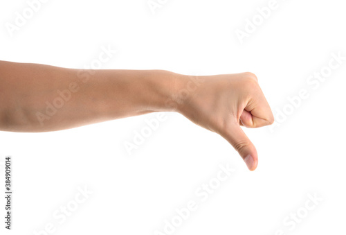 A hand making a thumbs down gesture in front of a white background