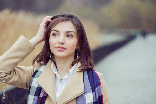 Young girl in coat thinking looking away. photo