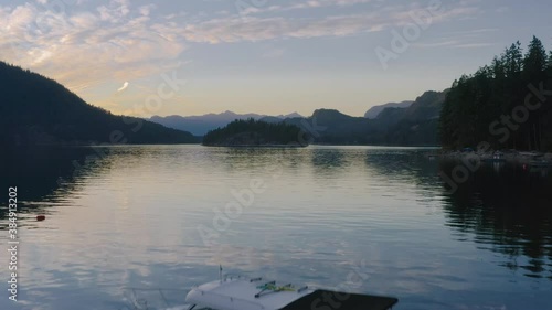 Speedboat Floating On The Calm Waters Of Sechelt Inlet On A Sunset - A Pacific Ocean Fjord Near The Egmont In Sunshine Coast, British Columbia, Canada. - aerial drone shot photo