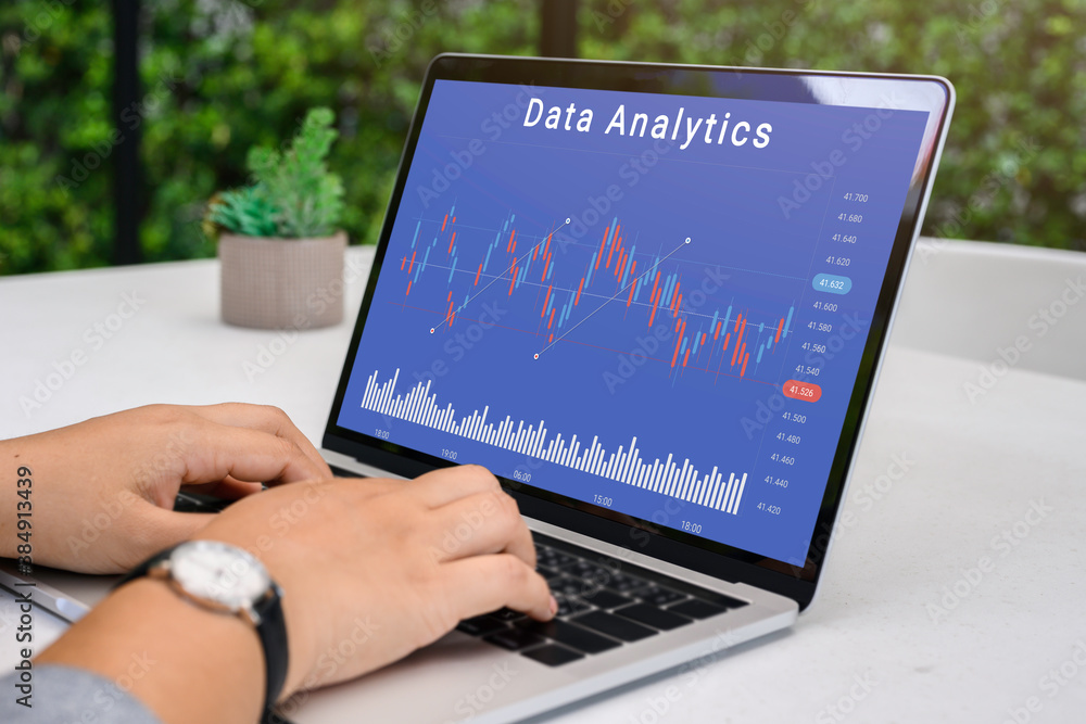 Businessman using a laptop computer with data analytics and statistics information business technology on table top. mockup with clipping path. Businessman using a laptop computer with data analytics and statistics information business technology on table top. mockup with clipping path.