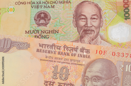 Wallpaper Mural A macro image of a orange ten rupee bill from India paired up with a colorful, plastic ten thousand dong note from Vietnam.  Shot close up in macro. Torontodigital.ca