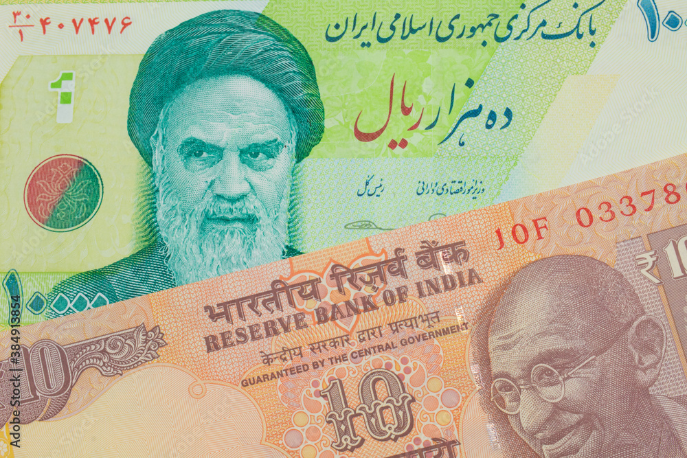 A macro image of a orange ten rupee bill from India paired up with a blue and green ten thousand rial bank note from Iran.  Shot close up in macro.