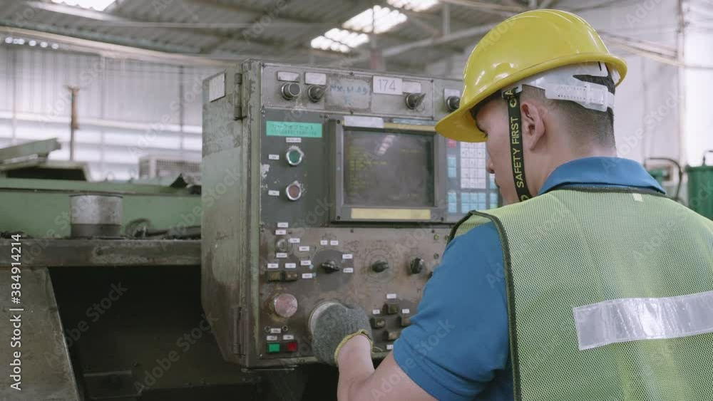 Maintenance engineer control automatic and pressing machine with panel in factory, system computer industrial, young asian man working, tool and equipment, industry and technology concept. Maintenance engineer control automatic and pressing machine with panel in factory, system computer industrial, young asian man working, tool and equipment, industry and technology concept.