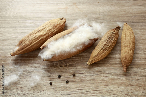 kapok seeds ( ceiba pentandra) on wood texture background