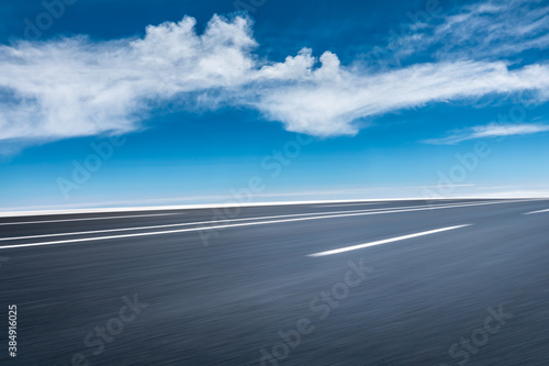 Motion blurred asphalt road and cloud scenery.