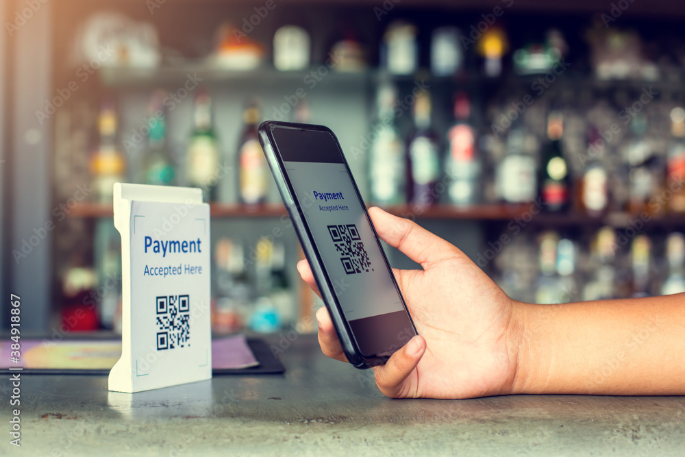 Hand holding smartphone to scan Qr code payment tag with blurry soft ...