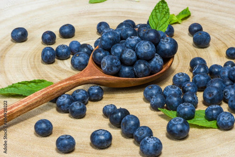 fresh blueberries in a wooden spoon over wooden table fresh blueberries in a wooden spoon over wooden table