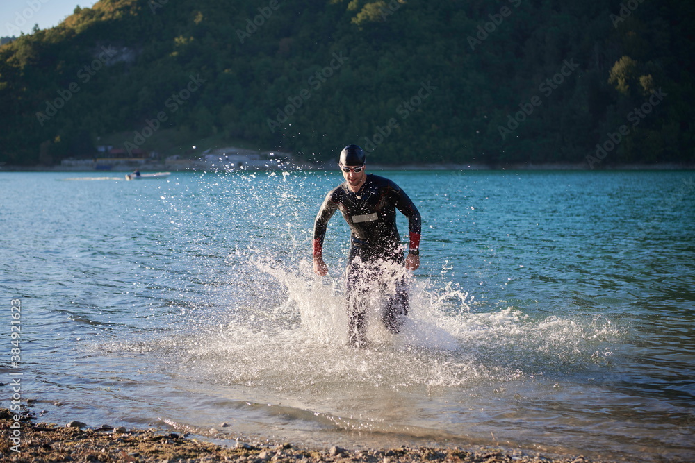 triathlon athlete starting swimming training on lake triathlon athlete starting swimming training on lake