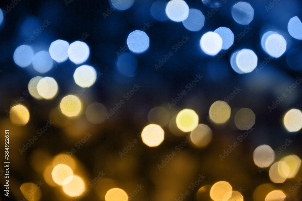 Christmas lights. Bokeh glows on a dark background. Christmas garlands with a blurred focus in the form of gold and blue bokeh. Christmas lights. Bokeh glows on a dark background. Christmas garlands with a blurred focus in the form of gold and blue bokeh.