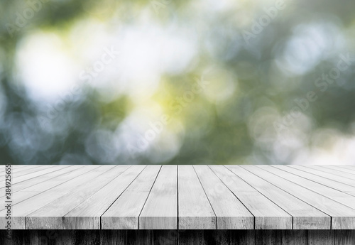 Wooden floor in front of blur bokeh backgrounds, use for display products.