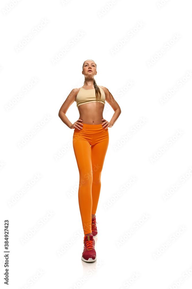 Strong fit woman with perfect body posing on white background Strong fit woman with perfect body posing on white background