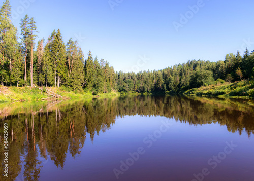 beautiful morning on the river, shore and tree reflections in the water, Gauja river, Latvia © ANDA