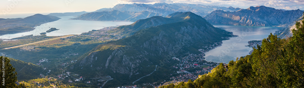 View to Kotor Bay from mountain serpentine road above the sky with clouds at sunset.