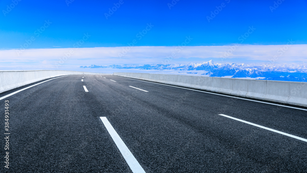 Fototapeta premium Asphalt road and mountain with sky clouds landscape.