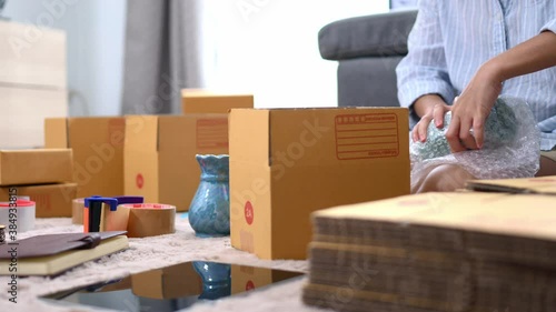 Close up business woman packing product to send to customer for the online order
