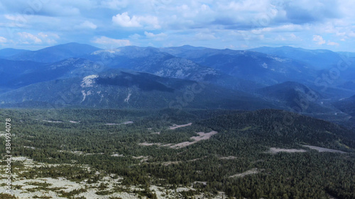 Landscape of scenic mountain forest background and peak of blue rock range.