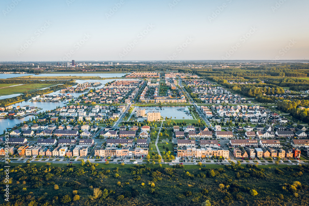 Modern suburban area Noorderplassen in Almere, The Netherlands, located on Flevoland polder, close to nature and the Nieuwe Land national park. Aerial view.