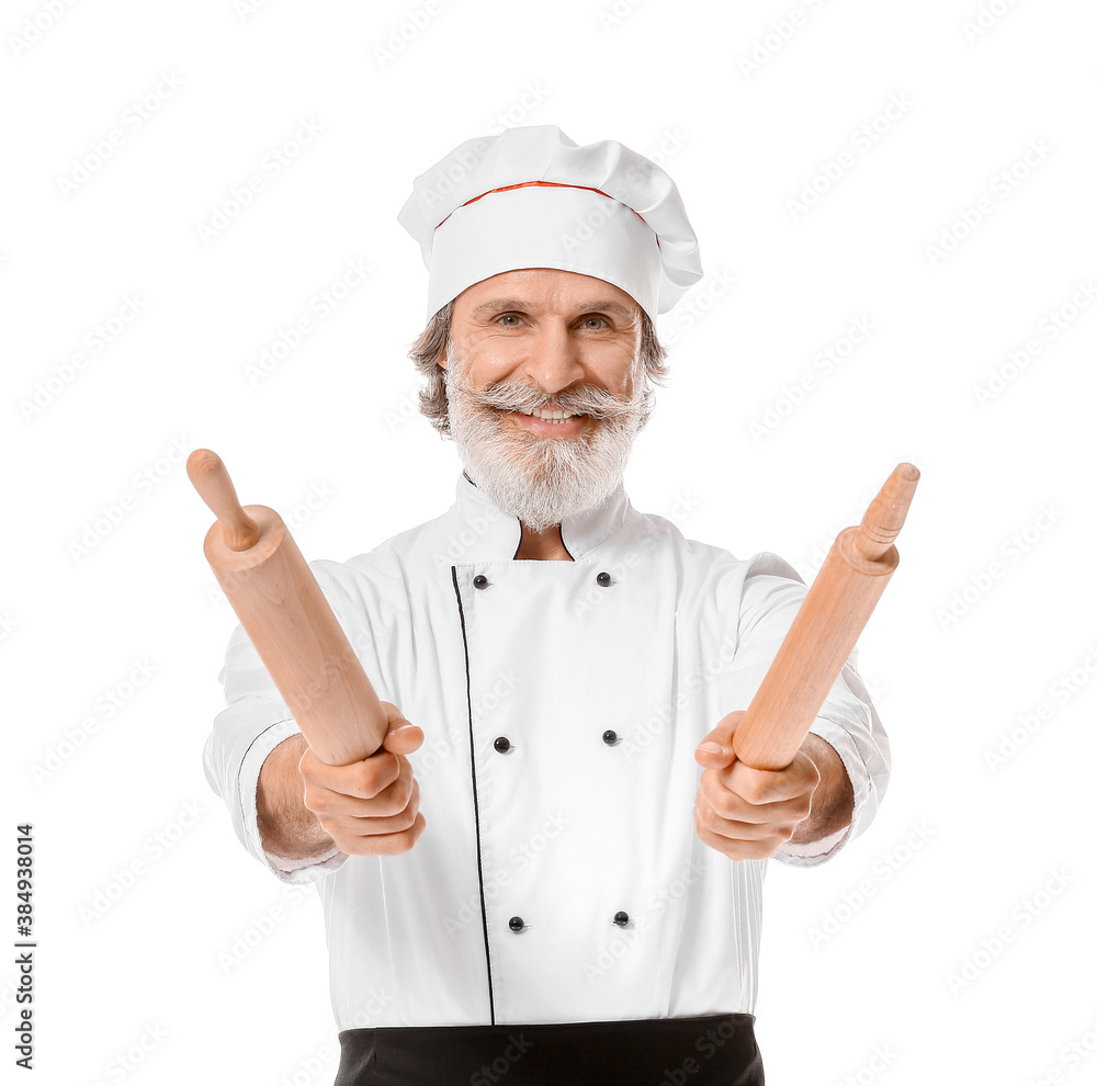 Mature male chef with rolling pins on white background Mature male chef with rolling pins on white background