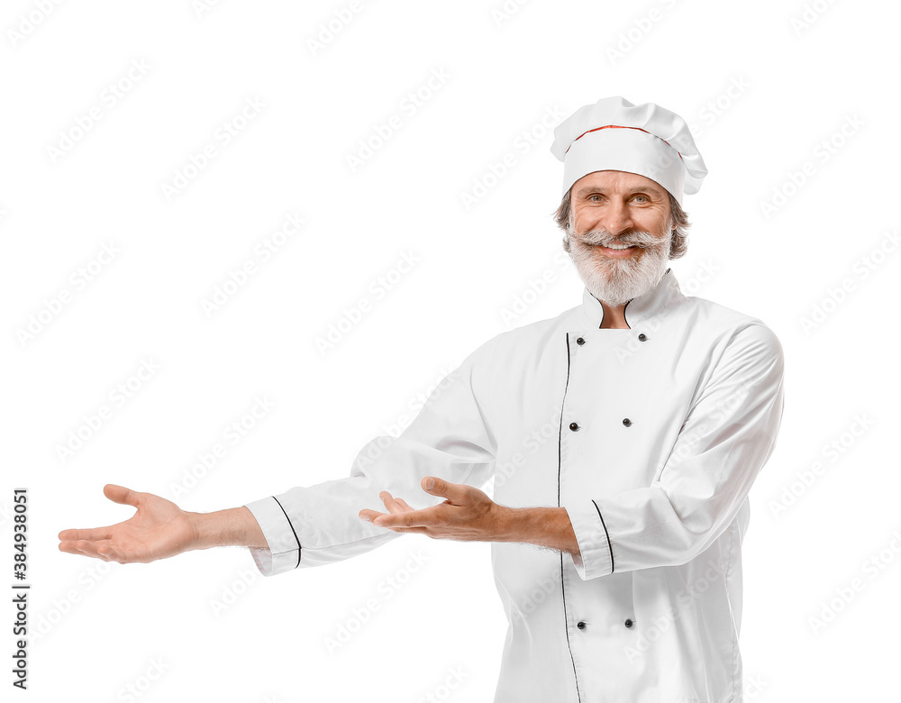 Mature male chef showing something on white background Mature male chef showing something on white background