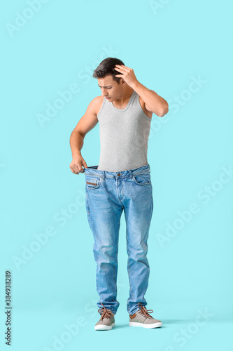 Принти на полотні Man with sudden weight loss problem on color background